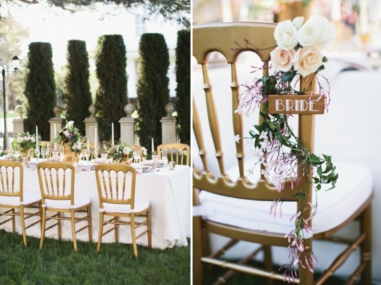 gold and white reception seating with floral bride seat sign
