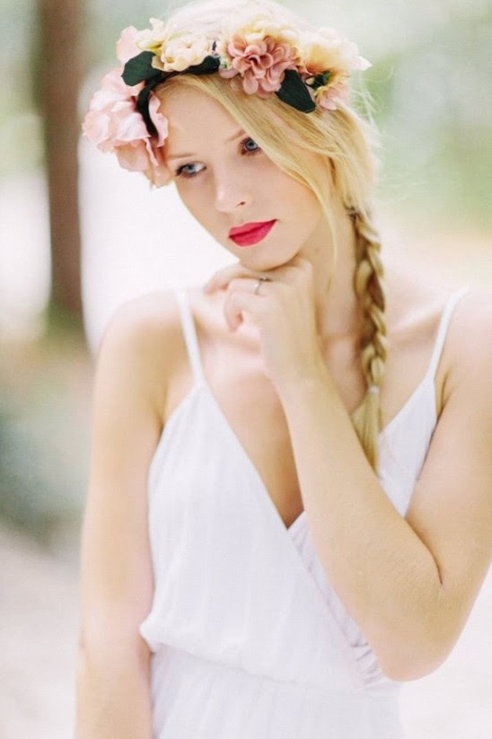 Blonde woman in white dress wearing flower crown