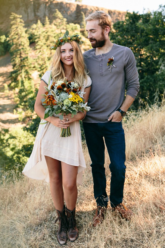 Rustic wedding couple in field, bride with floral crown