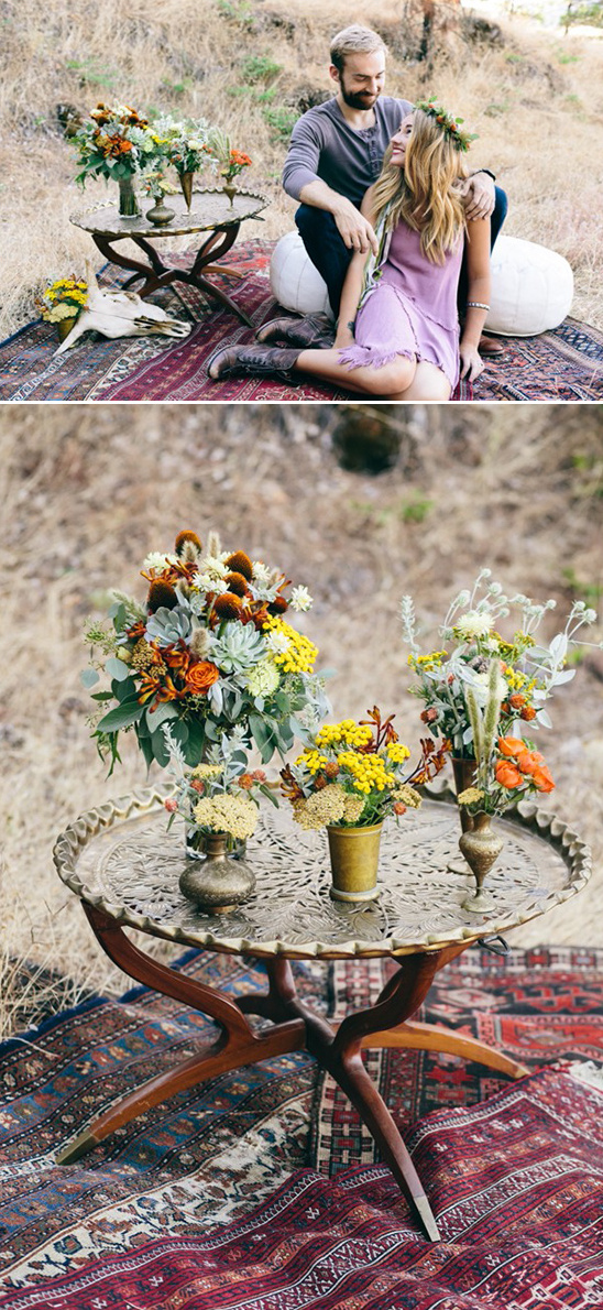 Romantic bohemian couple picnic with floral arrangements