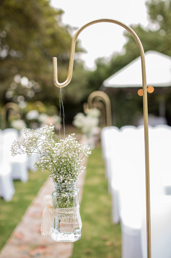 Wedding ceremony decoration featuring baby's breath in a jar