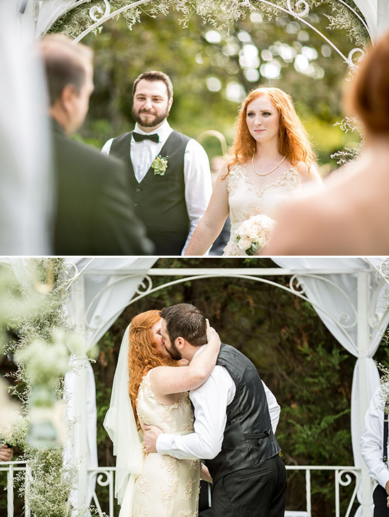 Bride and groom share a tender first kiss at their wedding ceremony
