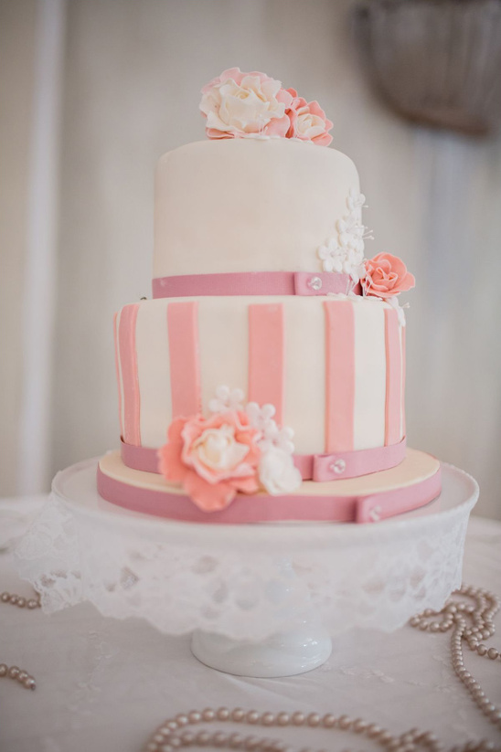 Elegant two-tier wedding cake with pink floral decorations
