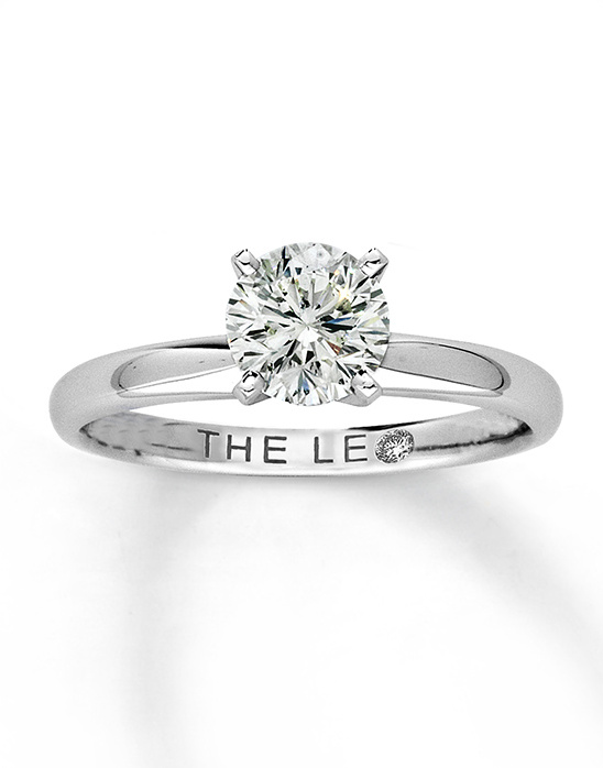 Elegant solitaire diamond ring on a white background
