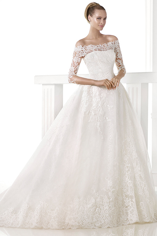 Elegant bride in a beautiful off the shoulder lace wedding gown