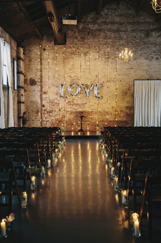 Romantic wedding ceremony with LOVE lights and candles