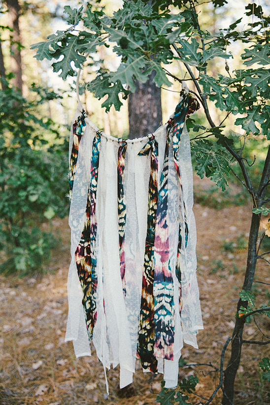 Dreamcatcher hanging on tree branch in forest setting