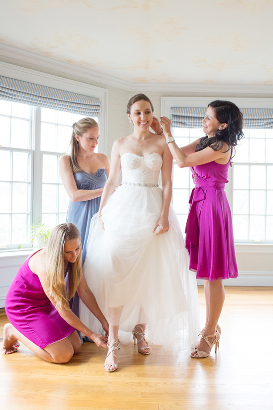 Bride getting ready with bridesmaids for her wedding day
