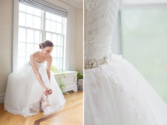 Bride putting on shoes in a bright room on her wedding day