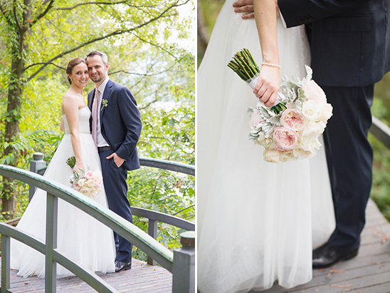 Bride and groom posing on a bridge with a beautiful bouquet