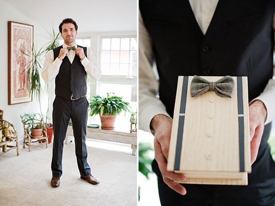 A man in a suit with a bow tie and unique gift box