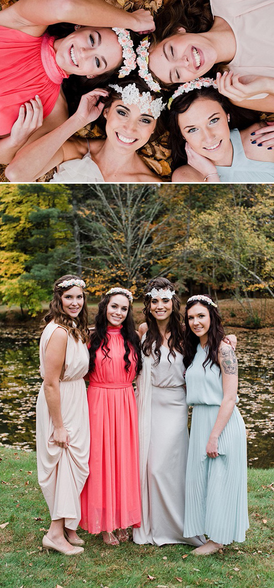 Bridesmaids in flowy dresses pose for a wedding photo with smiles