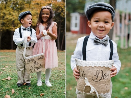 Adorable wedding attendants with Here comes the bride sign