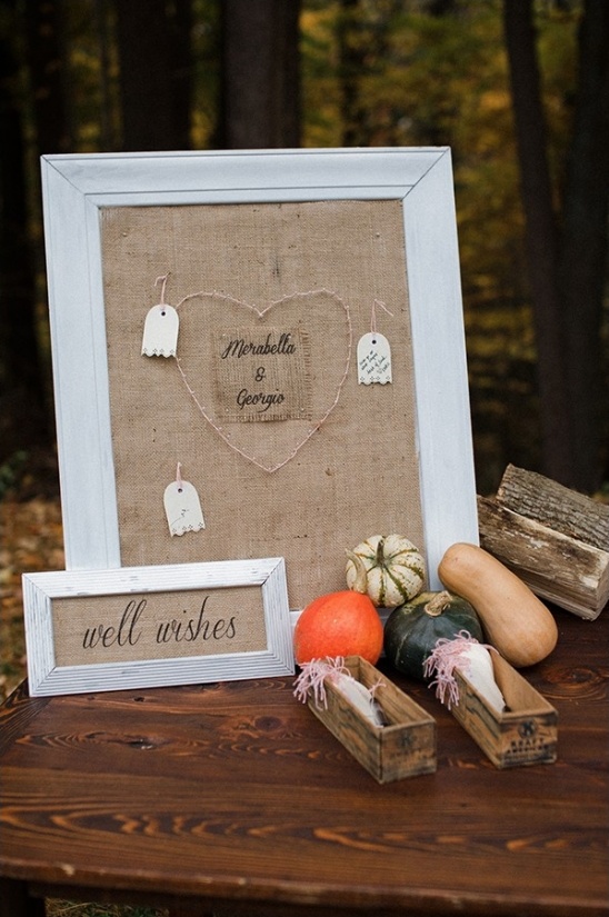 Rustic wedding sign with pumpkins and well wishes on display