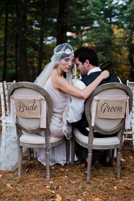 Bride and groom embrace at an outdoor wedding reception, rustic theme