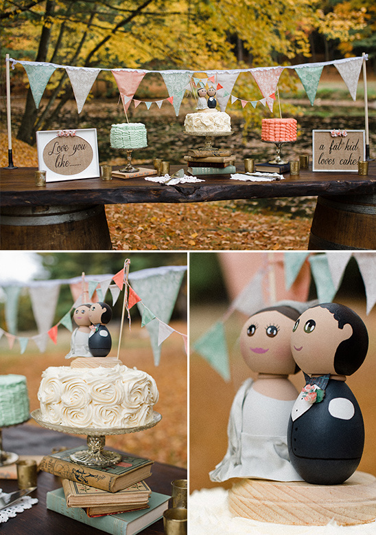 Rustic wedding cake display with banner and wooden cake toppers