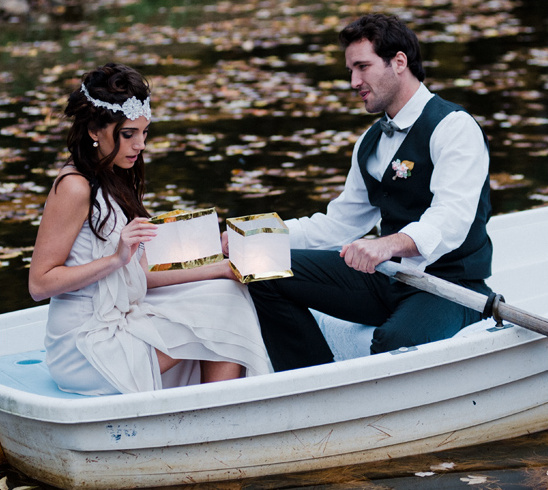 Couple in boat with lanterns, romantic wedding scene