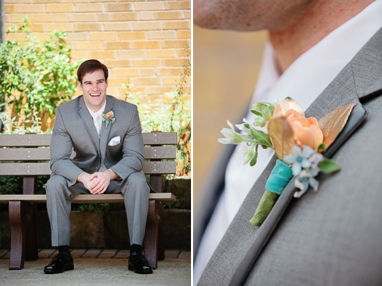 grey suited groom and gold and peach boutonniere