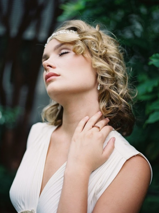Elegant bride with eyes closed outdoors in the sun