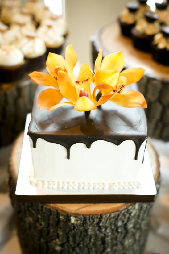 orange orchid topped wedding cake