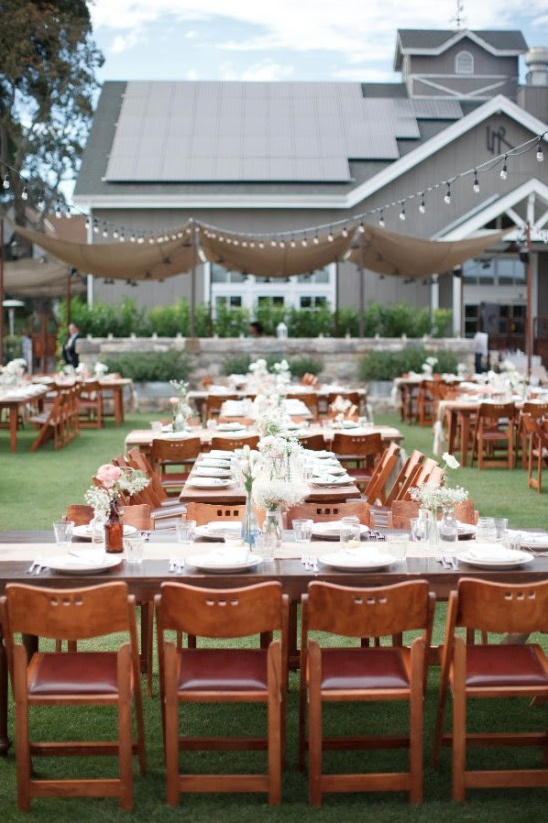 Wedding reception tables set up outdoors in a garden setting