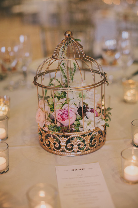 flowers in a gold birdcage