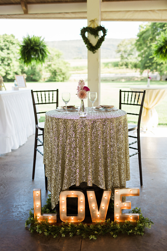 sweetheart table with love marquee sign