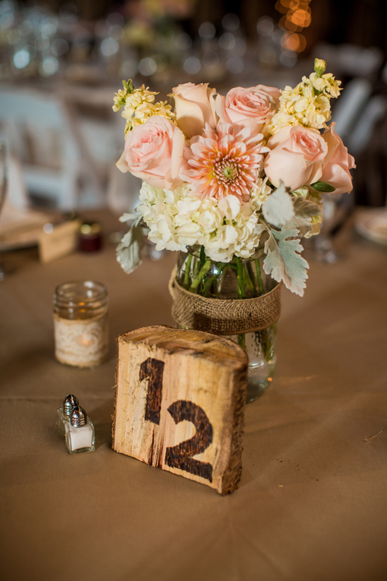 raw wood table number and peach centerpiece