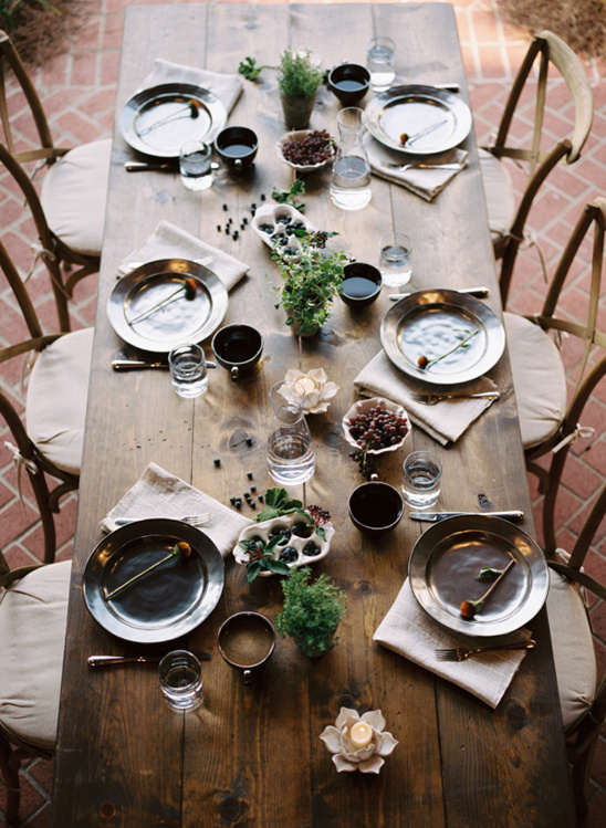 Rustic wooden table set for an outdoor dinner party