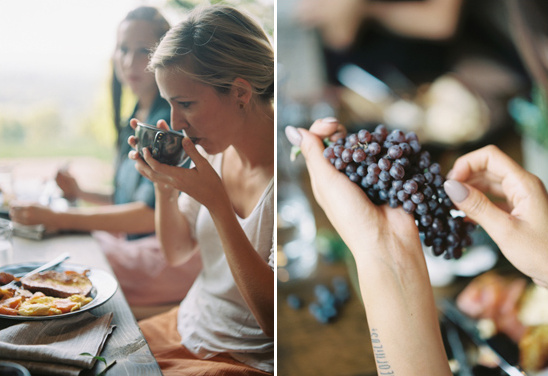 Woman sipping tea and holding grapes at a relaxing meal