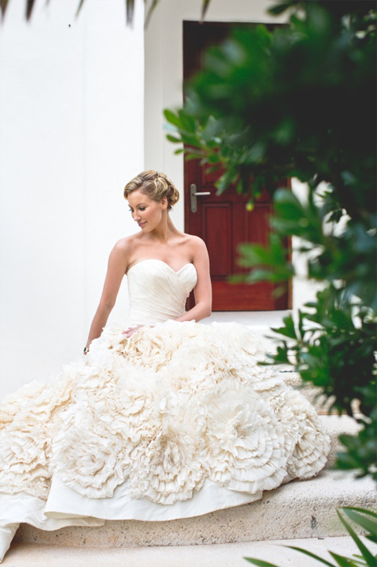 Bride in a floral wedding dress looking down
