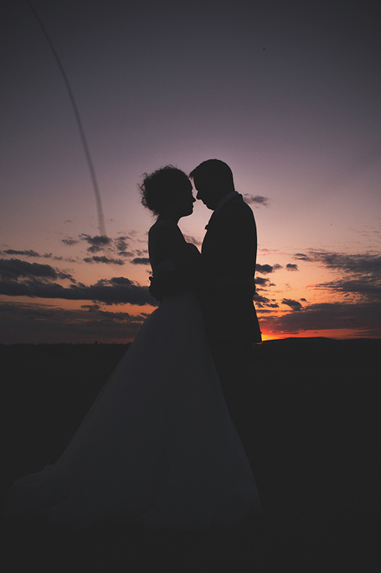 Romantic sunset silhouette of loving wedding couple