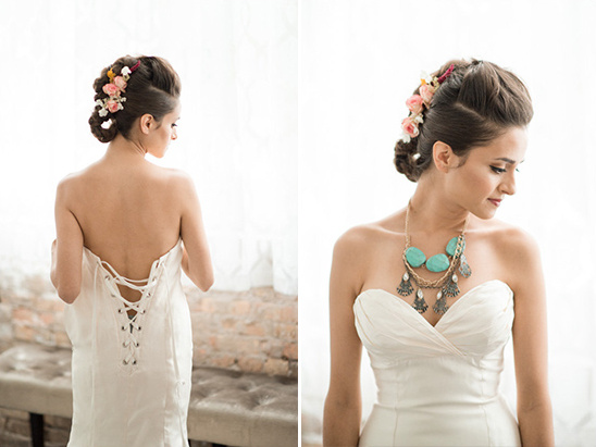 Bride in white dress with floral hair and necklace