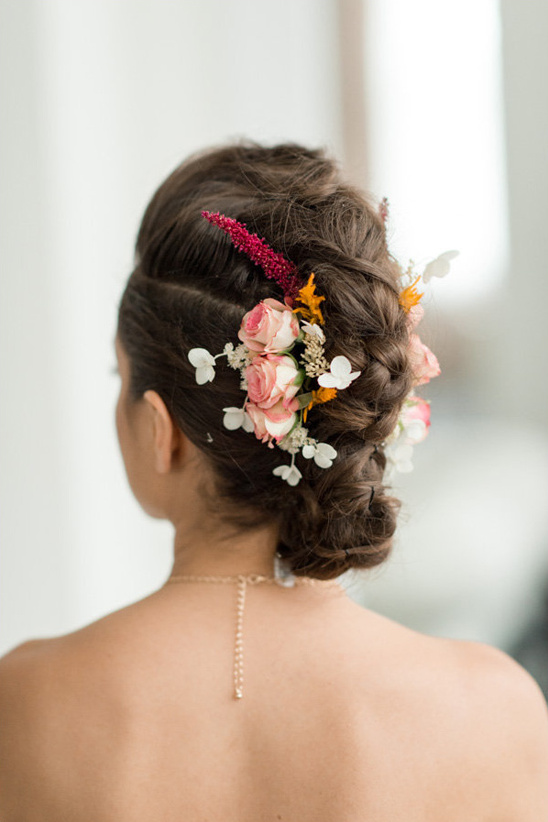 Elegant braided bridal hair with flowers and necklace
