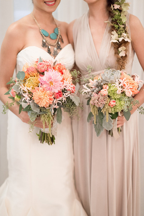 Bride and bridesmaid with colorful wedding bouquets