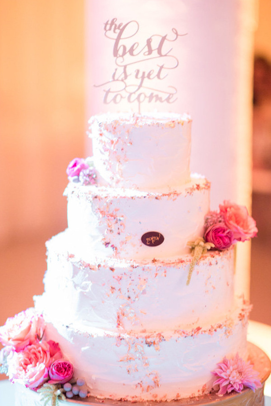 Elegant three-tier wedding cake with floral decorations