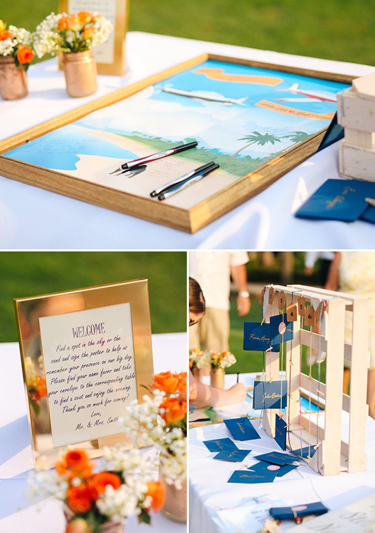 Beach wedding guestbook table with artwork and decor