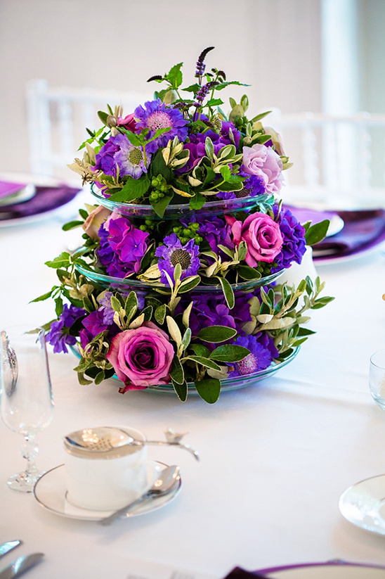 Elegant purple and pink floral centerpiece on wedding table