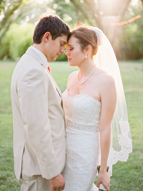 Bride and groom forehead to forehead on their wedding day