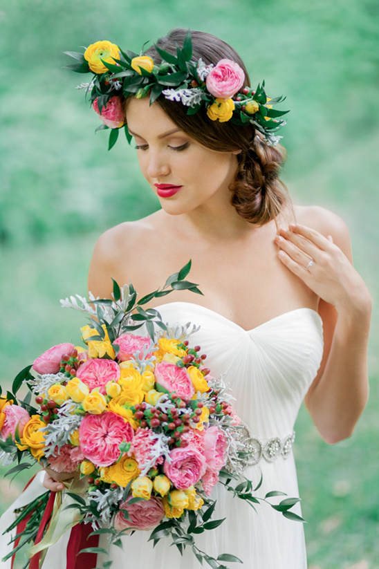Bride in floral crown holding vibrant wedding bouquet