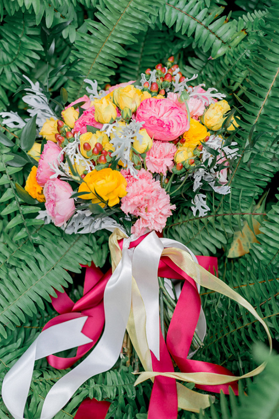 Pink and yellow bridal bouquet with colorful ribbons