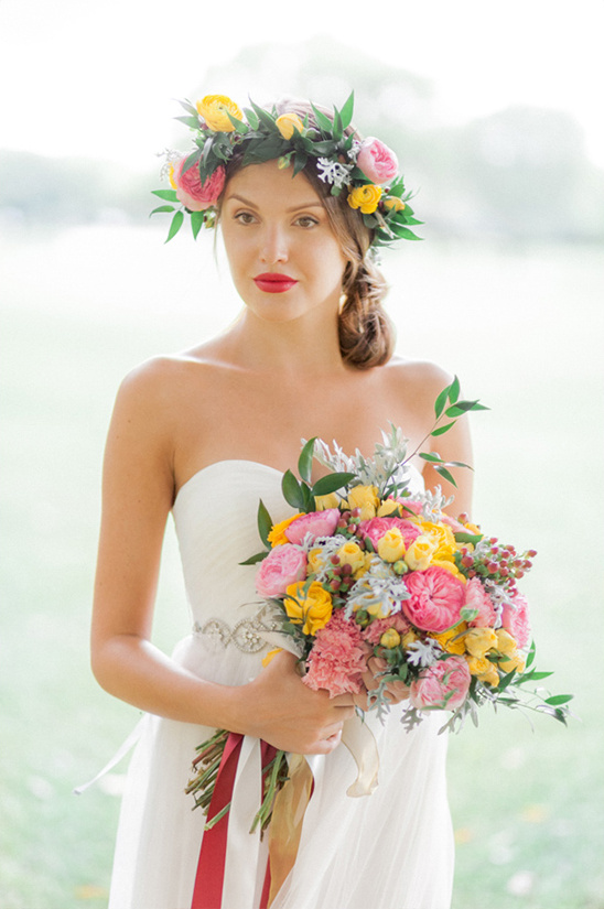 Bride with flower crown and colorful bouquet smiling