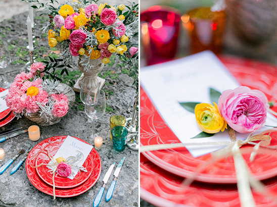 Elegant table setting with bright flowers and red plates