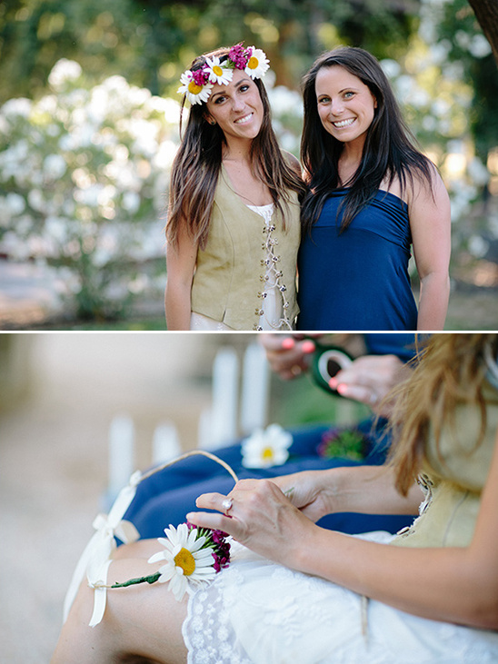 Two women making a daisy flower crown together outside
