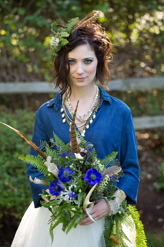 Bohemian bride with unique feather and antler bouquet