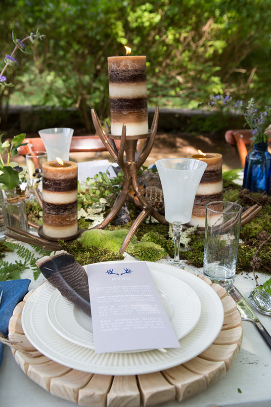 Rustic outdoor table candles moss antler feathers decor