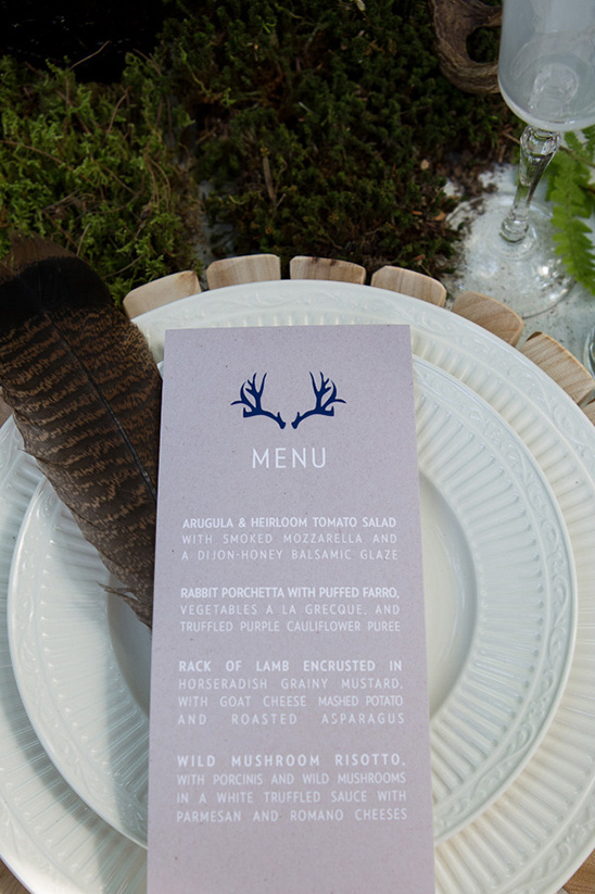 Rustic wedding menu card with antler design and feather