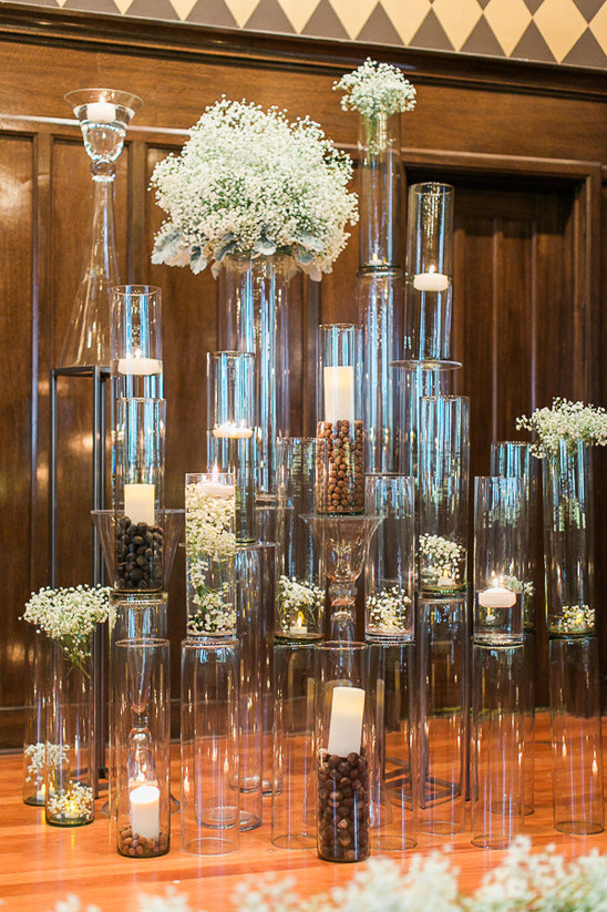 Elegant wedding centerpiece with glass vases and candles