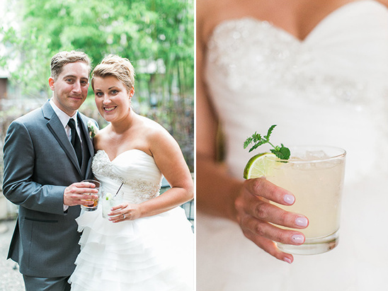 Happy bride and groom with cocktails at wedding party