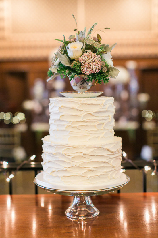 Elegant white wedding cake with beautiful floral arrangement